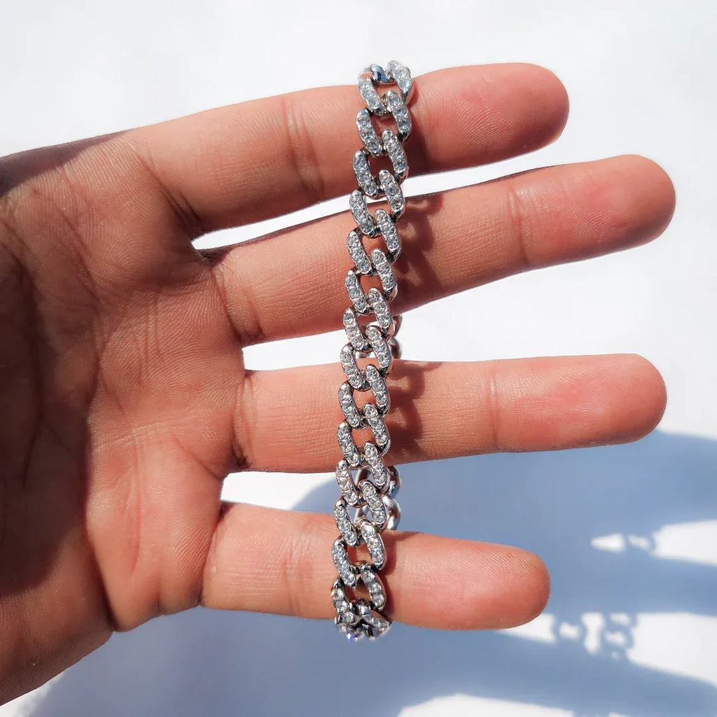 Macro detail of handset simulated diamonds and secure box clasp on silver cuban bracelet