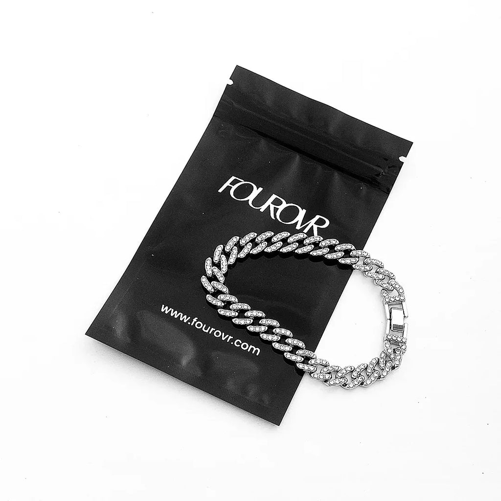 Man wearing silver diamond cuban bracelet on wrist streetwear style